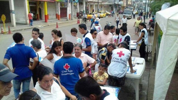 Personal del GAD municipal y de la Cruz Roja cantonal de Chone, promoviendo en la calle un Plan de Contingencia Familiar. Manabí, Ecuador.