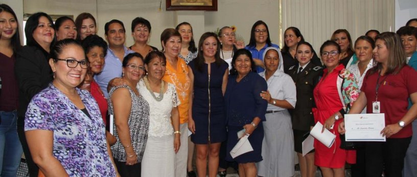 La Ministra de Justicia posa con un grupo de personas que trabajan para erradicar la violencia intrafamiliar en Manabí, Ecuador.