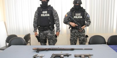 Dos policías del GIR custodian unas armas de fuego decomisadas en Murachi, San Isidro. Manabí, Ecuador.